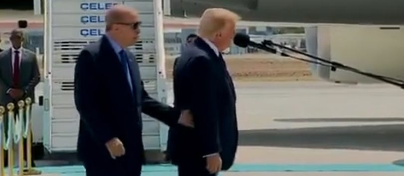trump is so out of it at the nato summit that he is being guided around by hand